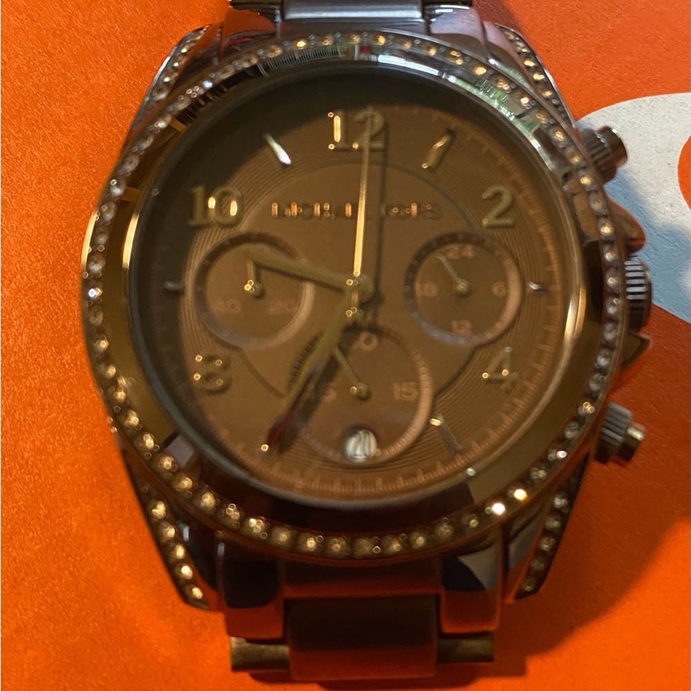 Micheal Kors copper and brown  color watch with gem stone accents .